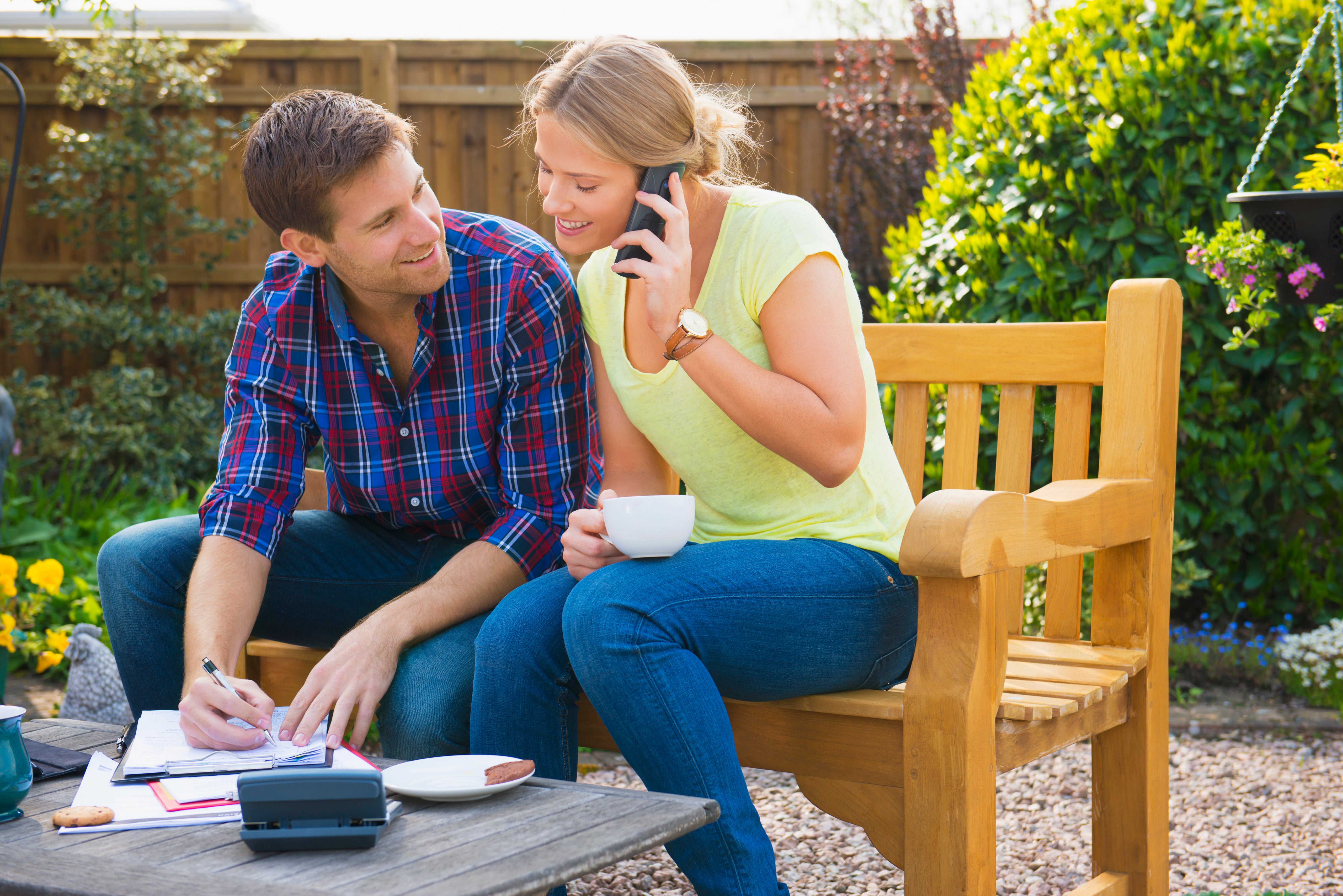 young couple cell phone talking outside