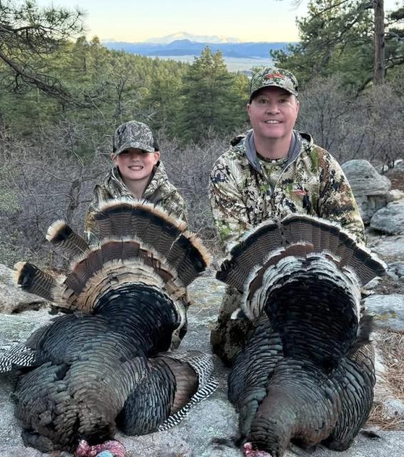 Coye Elliott and young hunter with turkeys
