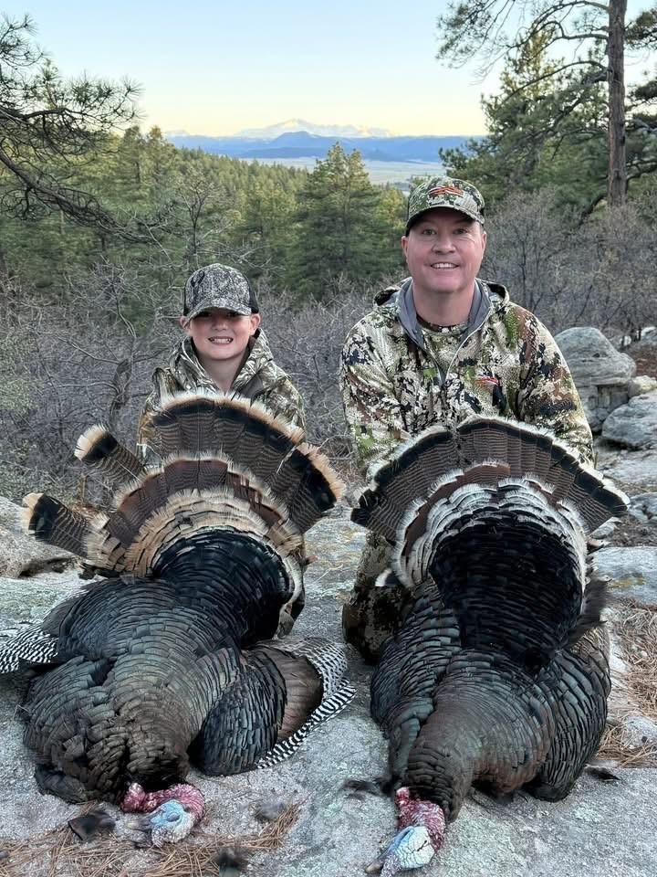 Coye Elliott and young hunter with turkeys